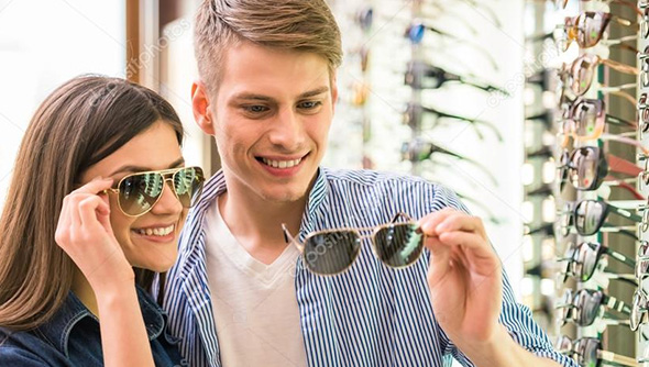 Man and woman trying designer frames for glasses and sunglasses