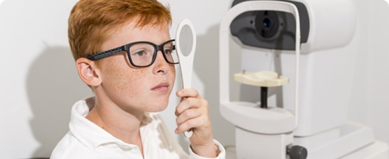 Child having eyesight tested during eye check